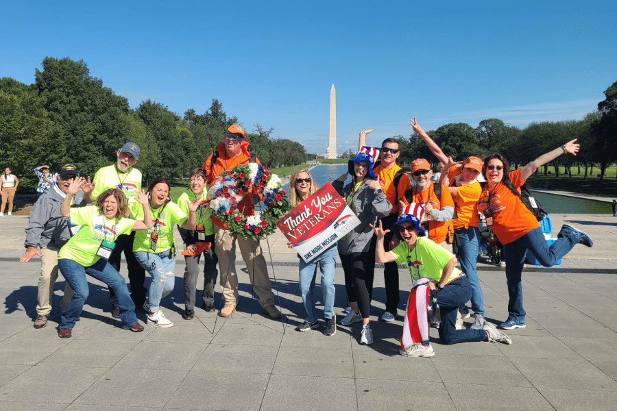 Volunteers at the Washington Memorial with a thank you veterans sign